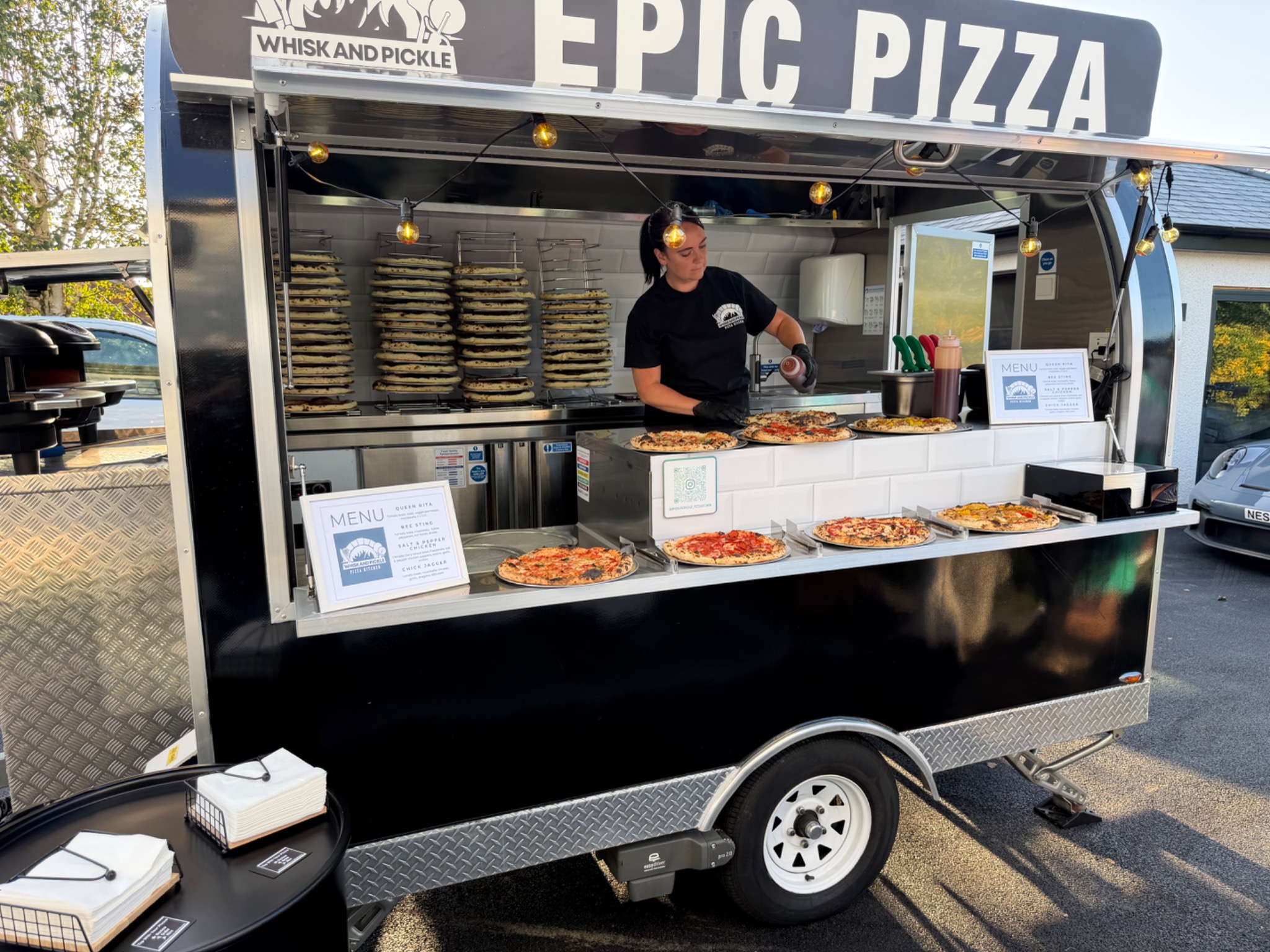 Whisk And Pickle mobile pizza kitchen serving an event