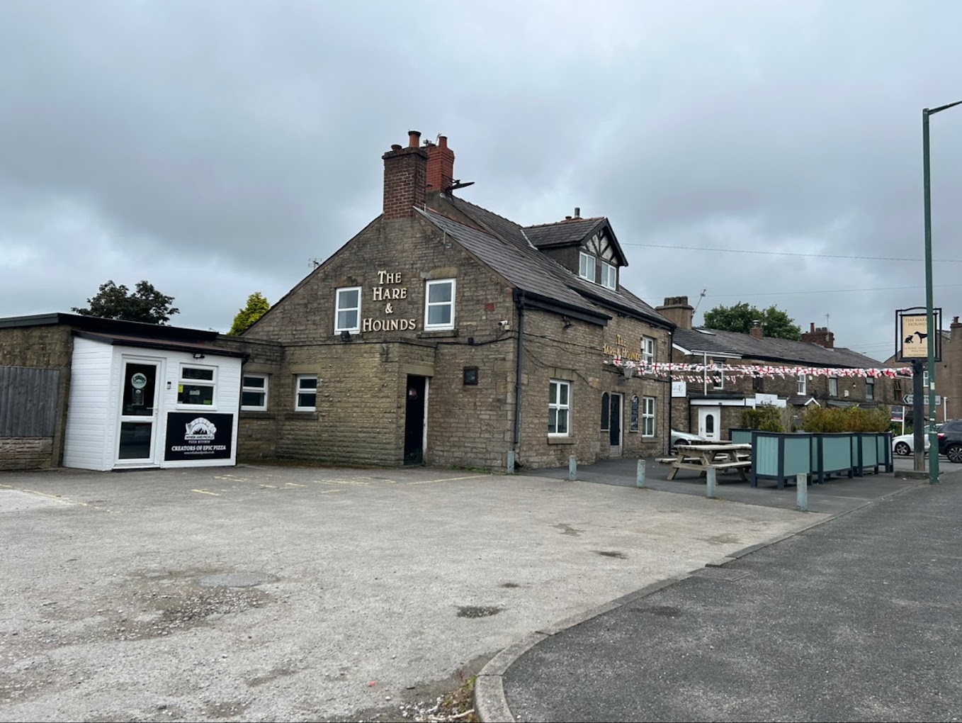 Whisk And Pickle Pizza Kitchen in the white building beside the Hare and Hounds pub, with access through the car park